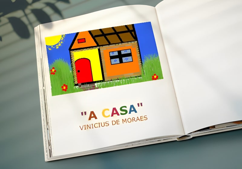 vista superior de livro aberto com imagem da capa do poema a casa de vinicios de moraes