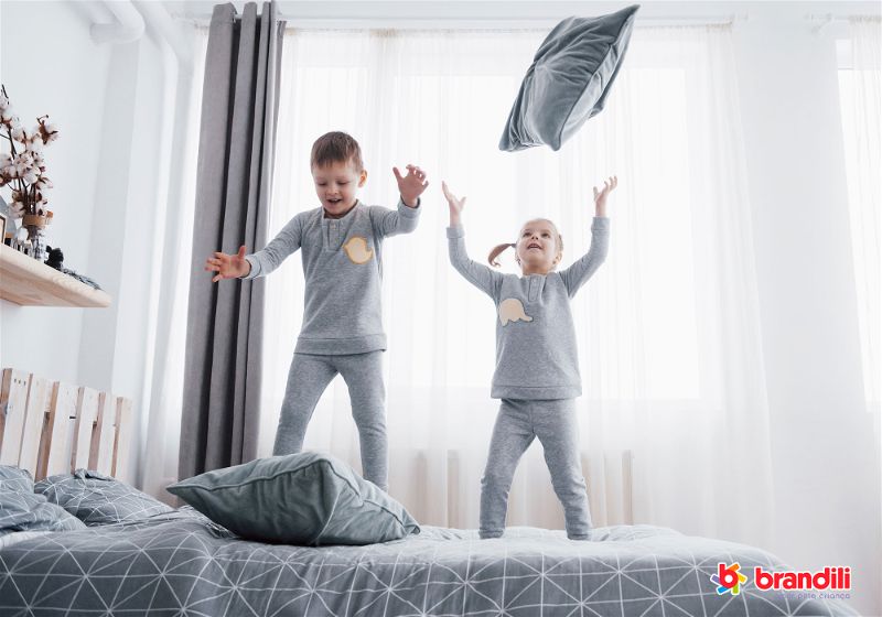 crianças pulando na cama
